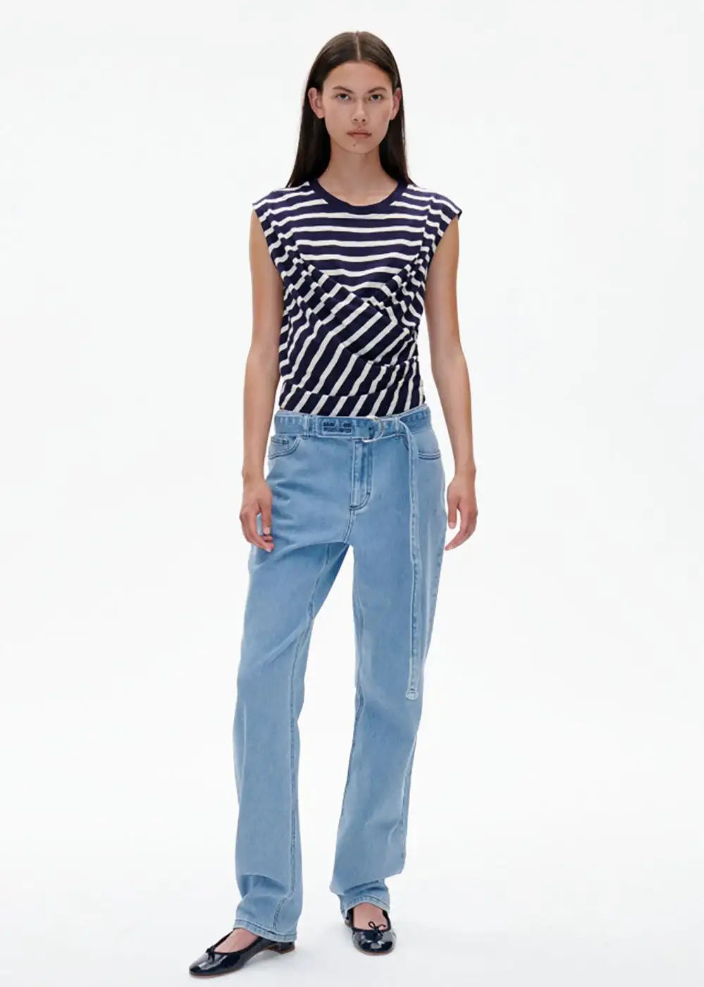 Woman wearing navy striped sleeveless top and light blue relaxed-fit jeans fashion look
