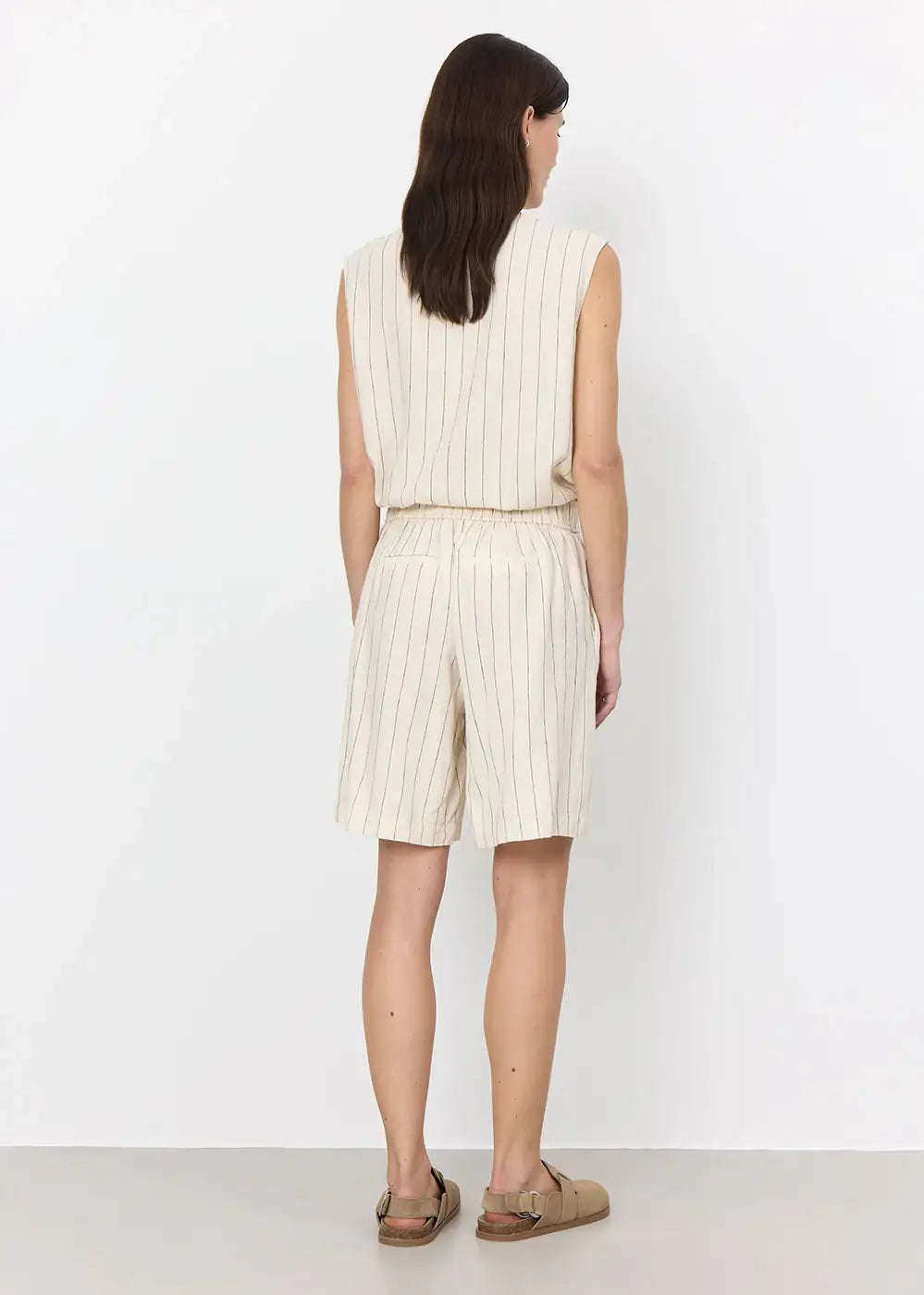 Woman wearing cream sleeveless pinstripe top and shorts set, back view, casual summer outfit