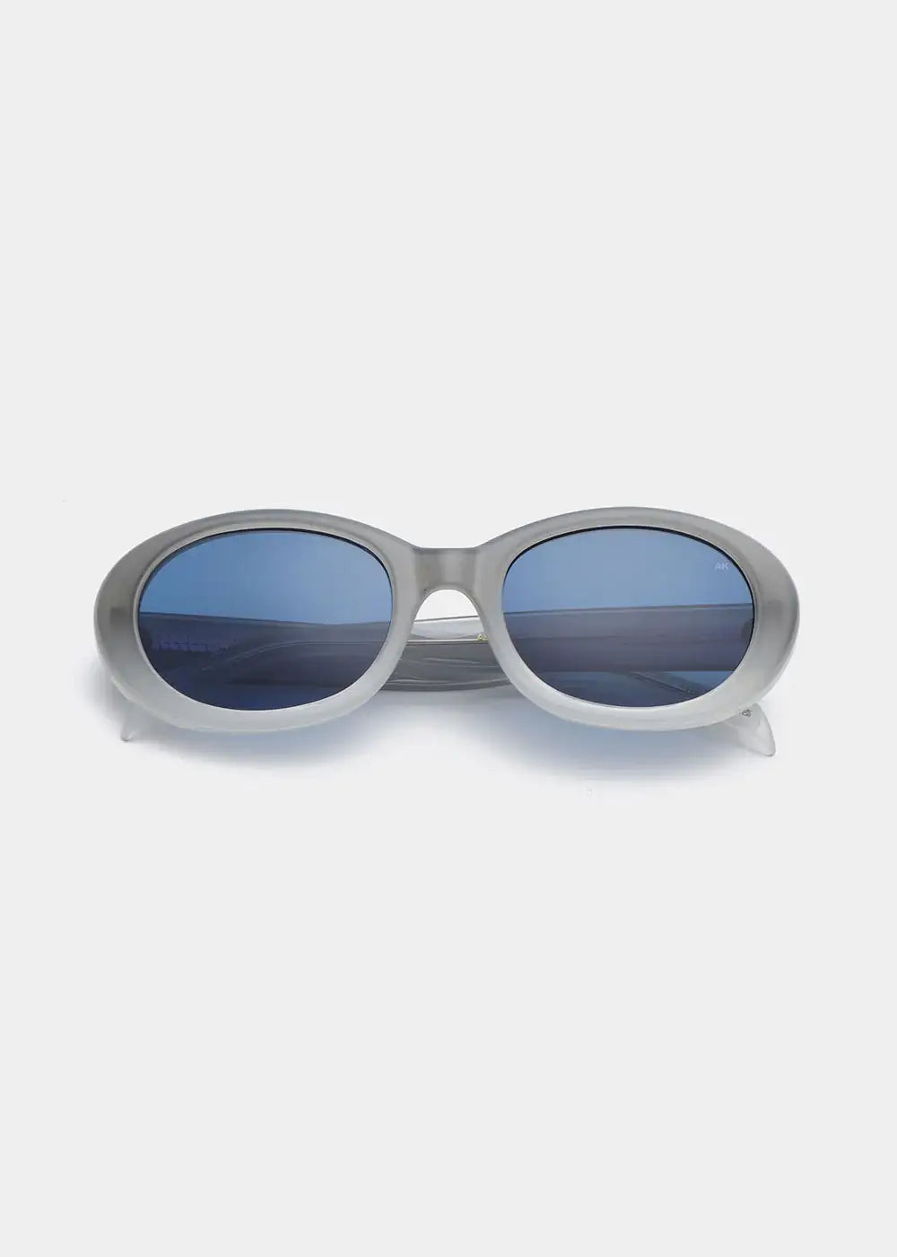 Oval grey sunglasses with blue lenses on white background, modern fashion eyewear
