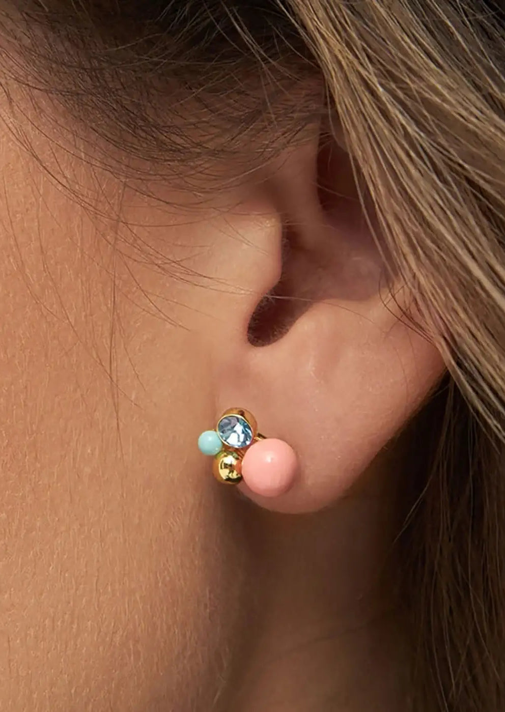 Gold plated stud earring with coral, aqua, and blue crystal beads on ear
