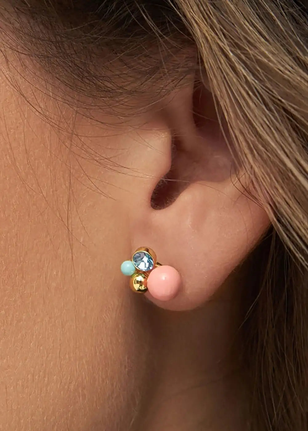 Gold plated stud earring with coral, aqua, and blue crystal beads on ear