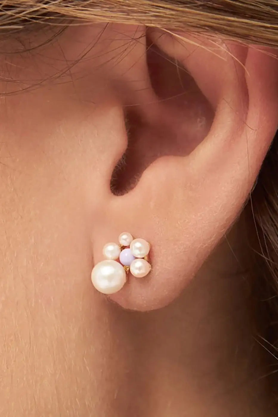 Gold plated ear stud with clustered pearls and lavender accent on ear