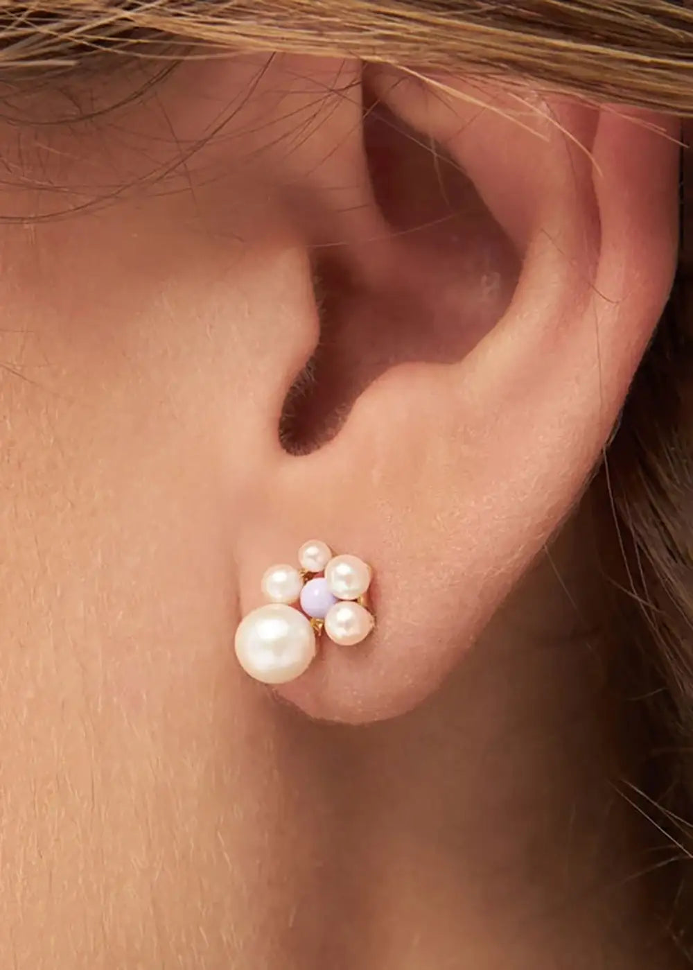 Gold plated ear stud with clustered pearls and lavender accent on ear