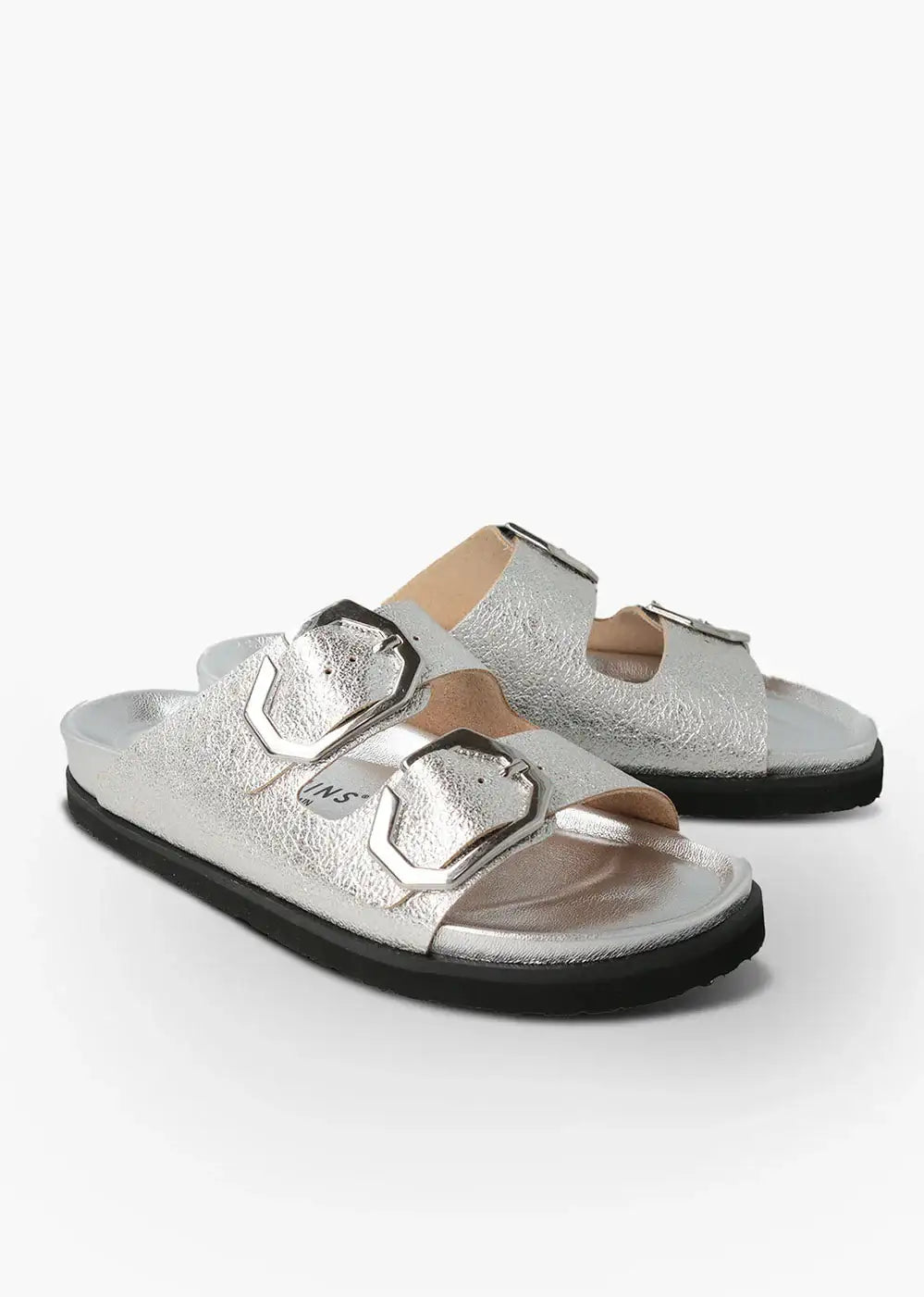 Silver metallic slip-on sandals with double buckle straps and black soles