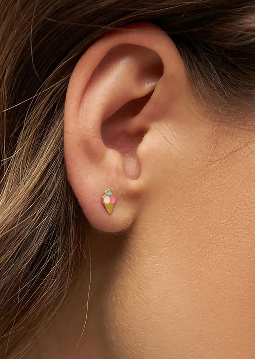 Gold plated ice cream cone stud earring worn on ear, colorful and dainty fashion jewelry