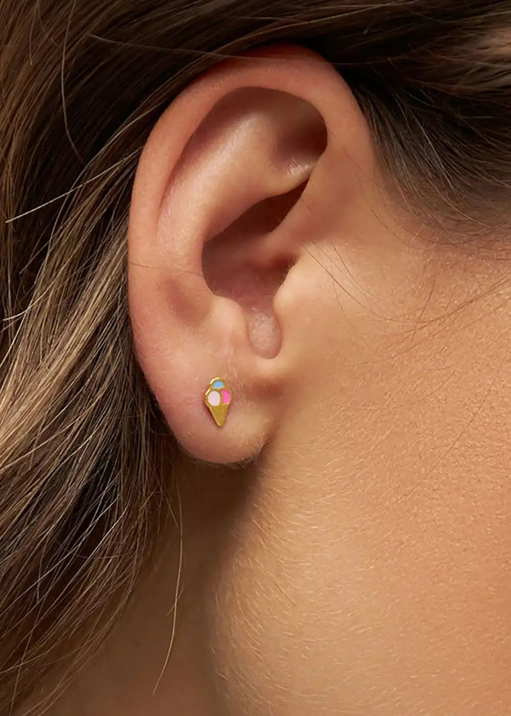 Gold plated ice cream cone stud earring worn on ear, colorful and dainty fashion jewelry