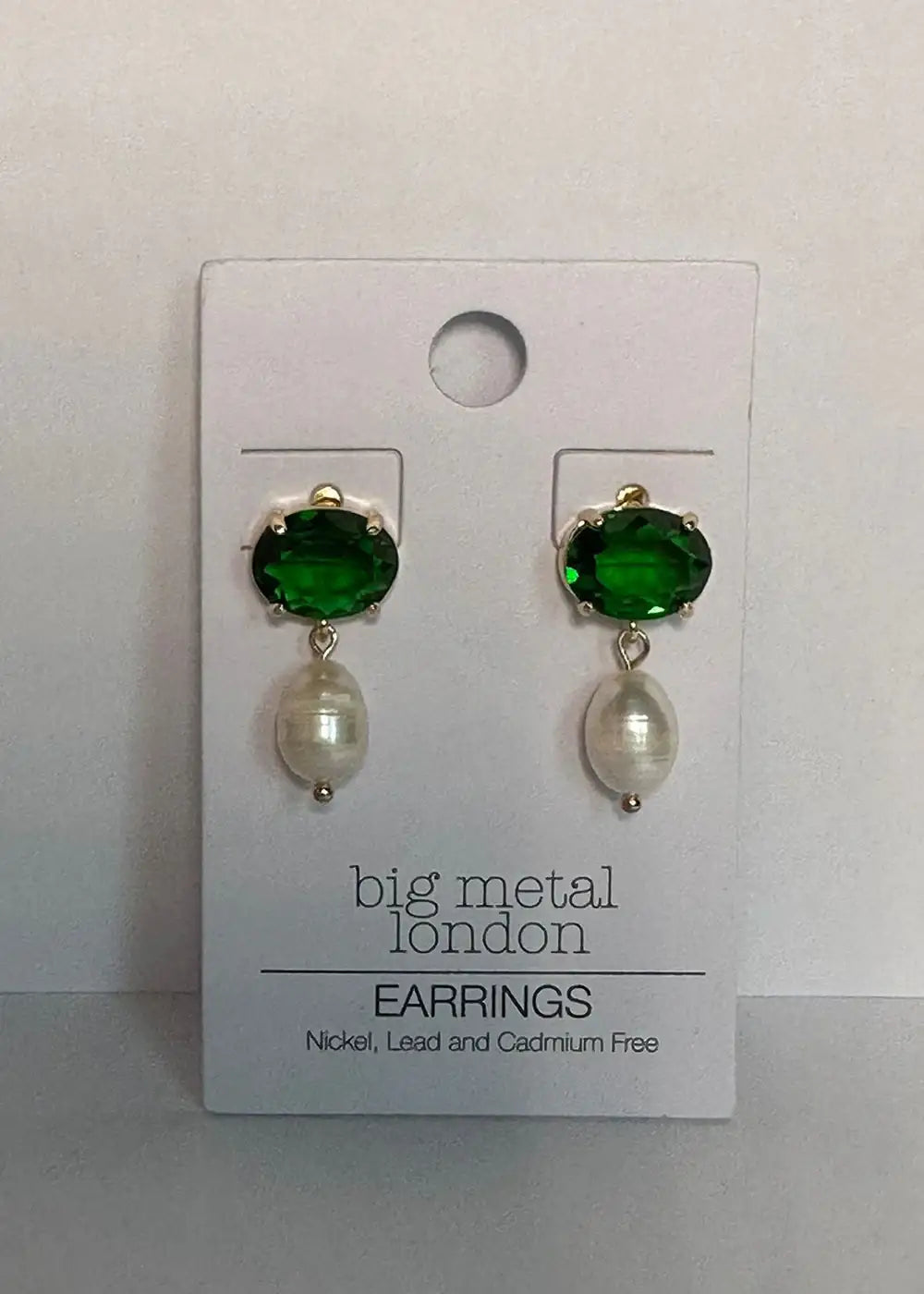 Green crystal and pearl drop earrings on display card, elegant fashion jewelry