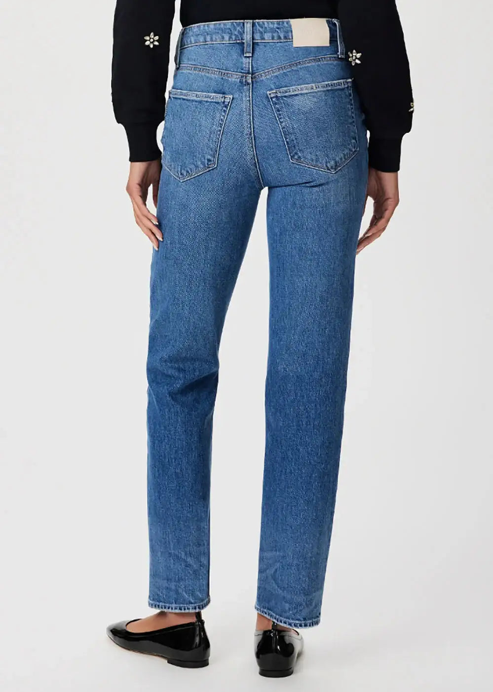 Back view of straight leg blue jeans with high waist on model