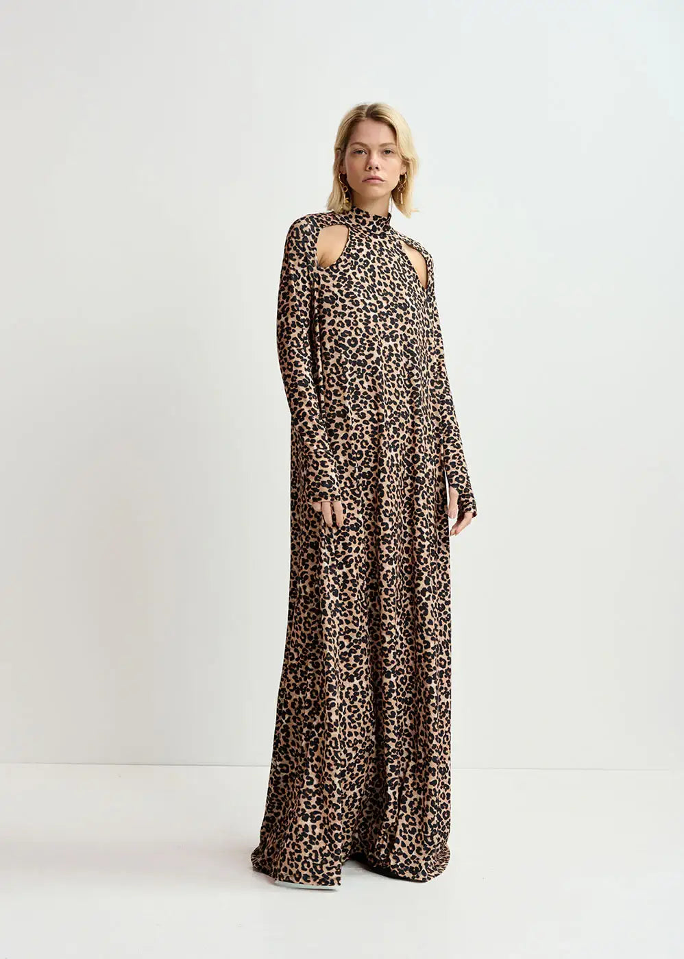 Woman wearing a long leopard print dress with high neck and shoulder cut-outs