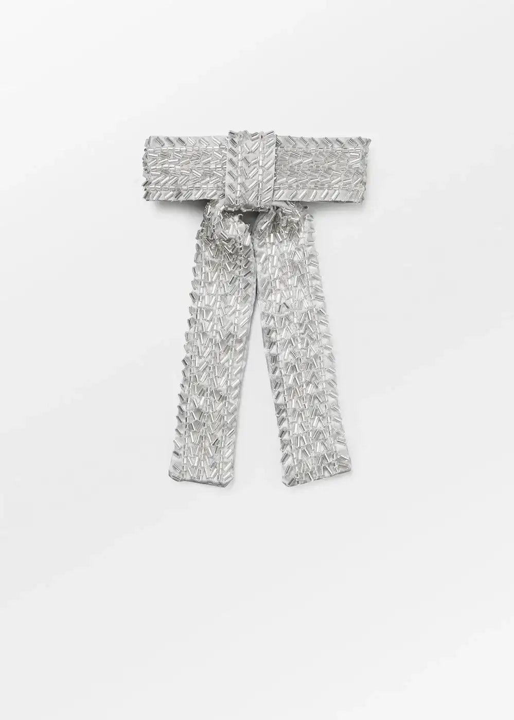 Silver sequin embellished bow brooch with beaded detail on white background