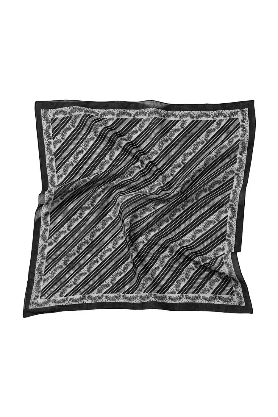 Black and white patterned silk scarf with diagonal stripes and floral border