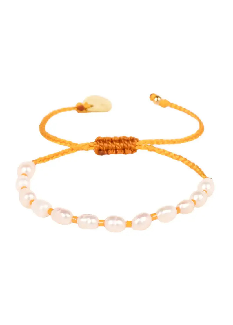 Yellow adjustable bracelet with white freshwater pearls on a white background