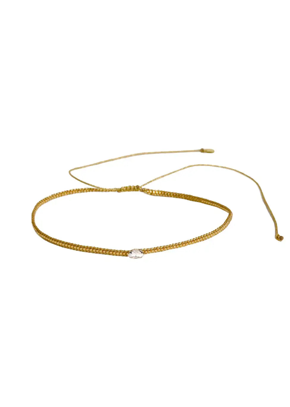 Gold adjustable bracelet with central diamond-shaped clear crystal bead