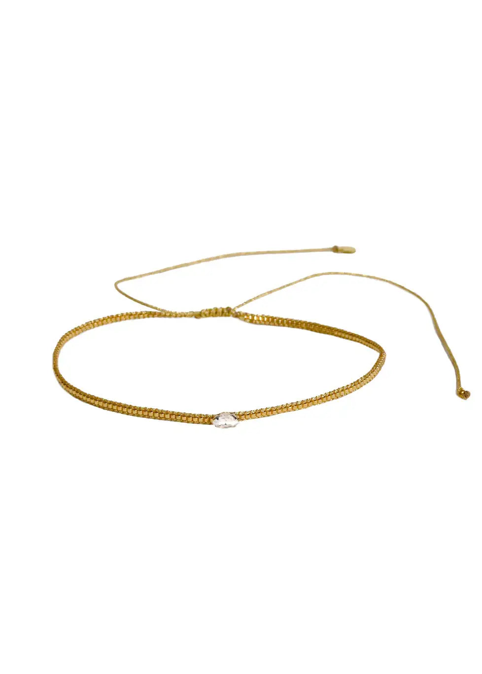 Gold adjustable bracelet with central diamond-shaped clear crystal bead