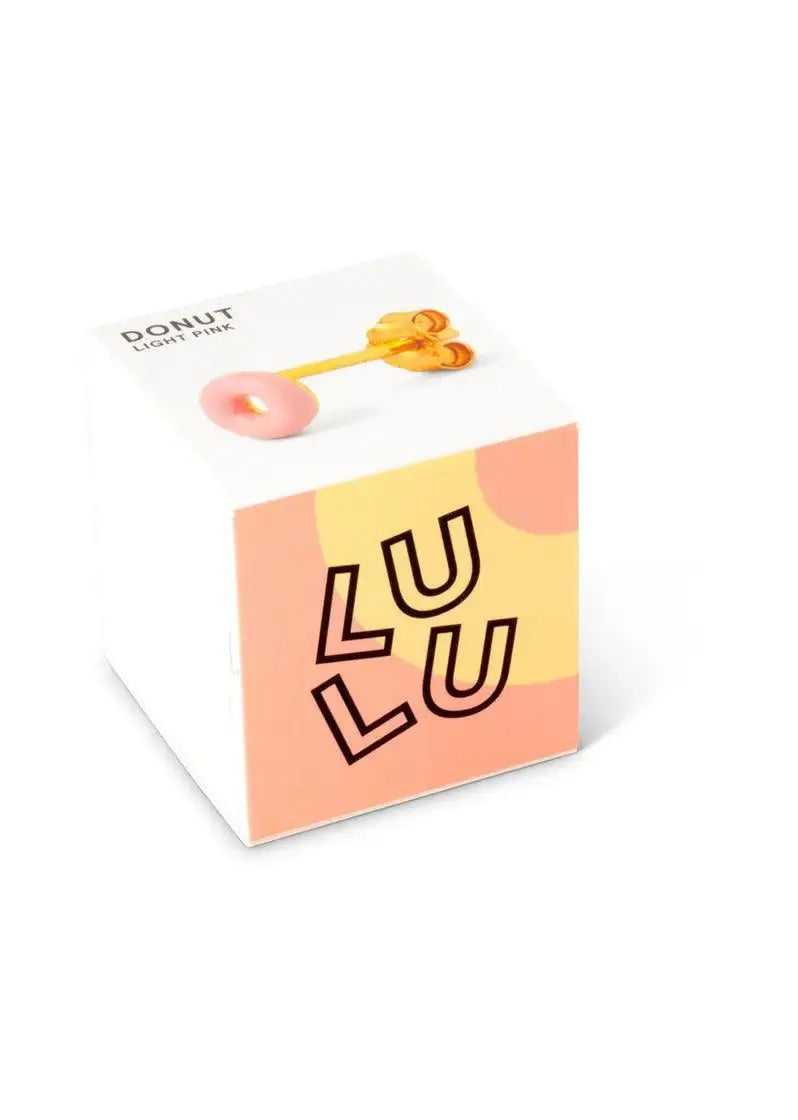 Light pink donut-shaped enamel stud earring displayed on a colorful box