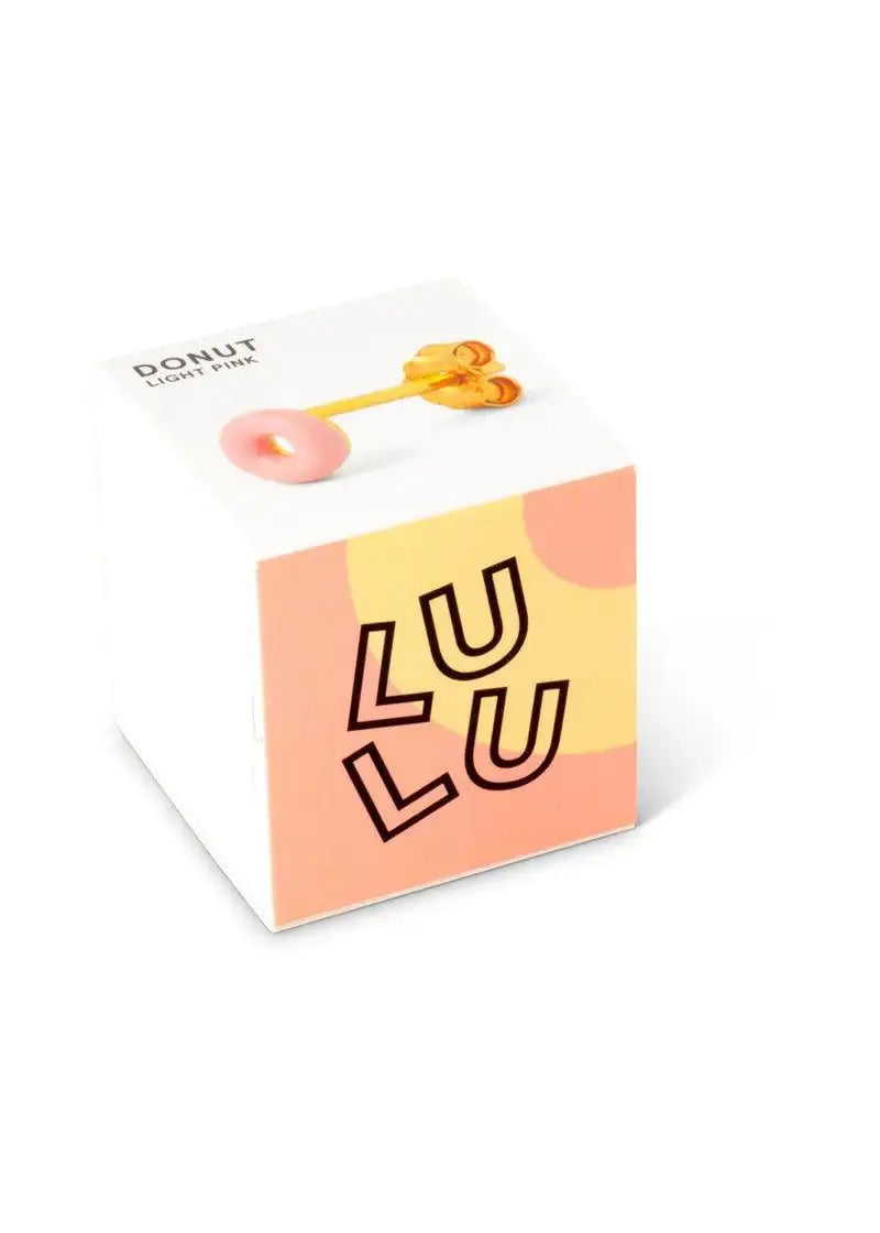 Light pink donut-shaped enamel stud earring displayed on a colorful box