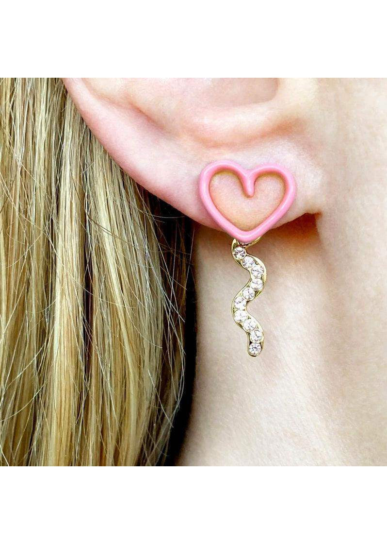 Pink heart-shaped earring with gold crystal dangle worn on ear