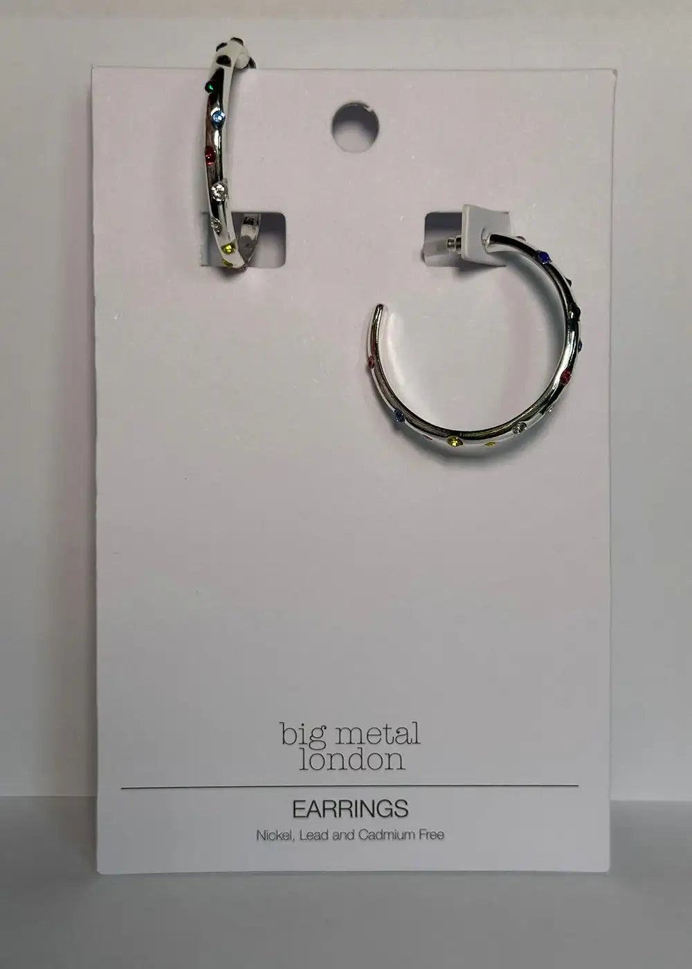 Silver hoop earrings with multicoloured gemstones on a display card, contemporary jewellery