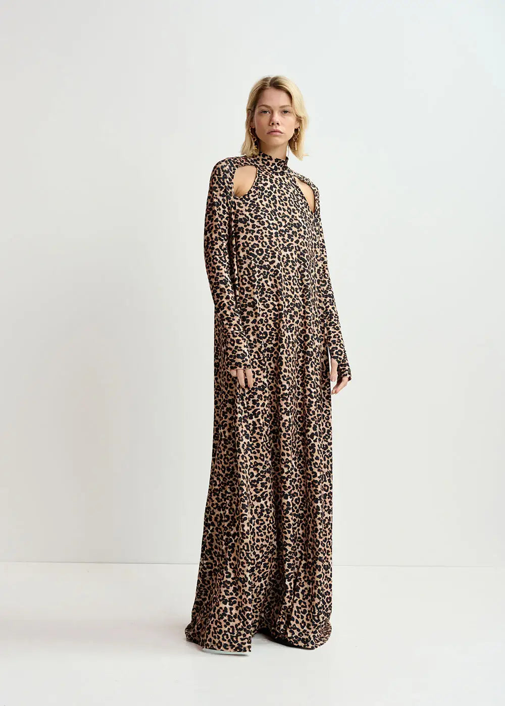 Woman wearing a long leopard print dress with high neck and shoulder cut-outs